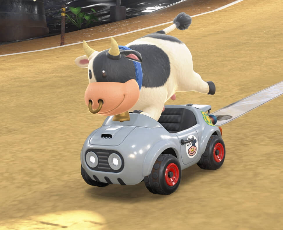 A cow standing on its feet in a kart.
