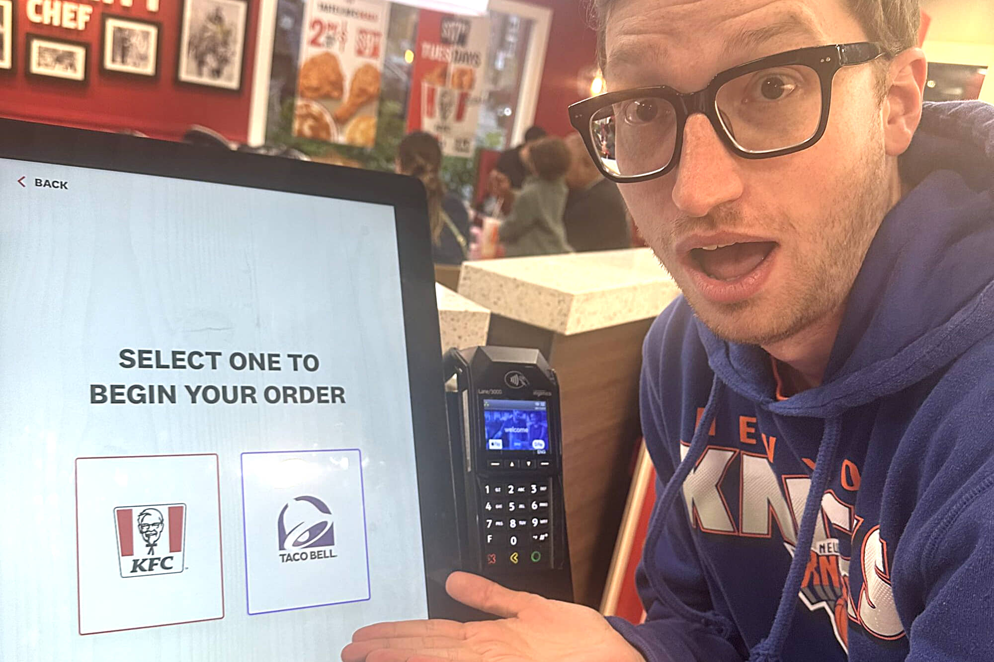 jared pointing to a screen at the Taco Bell KFC